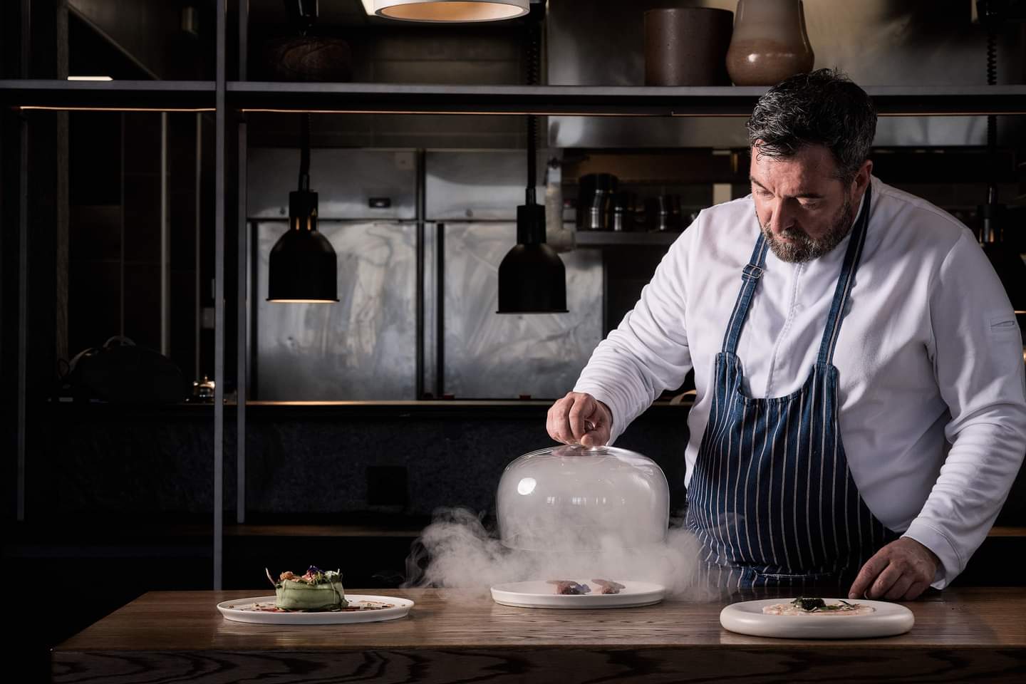 Chef Stefanos Kokkalis presenting dishes in a professional kitchen